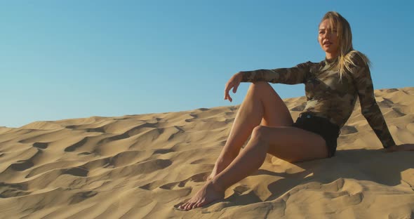 Portrait of a Pretty Lady Sitting on the Side of a Sand Dune Dubai UAE
