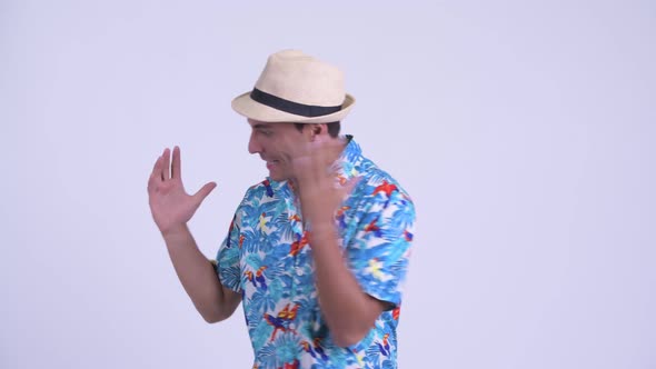 Young Happy Hispanic Tourist Man Presenting Something and Looking Excited