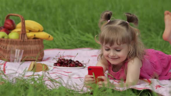 Weekend at Picnic. Girl on Grass Meadow Play Online Games on Mobile Phone. Social Network, Chatting