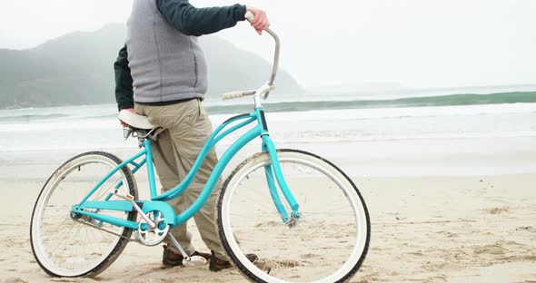 Senior man standing with his bicycle