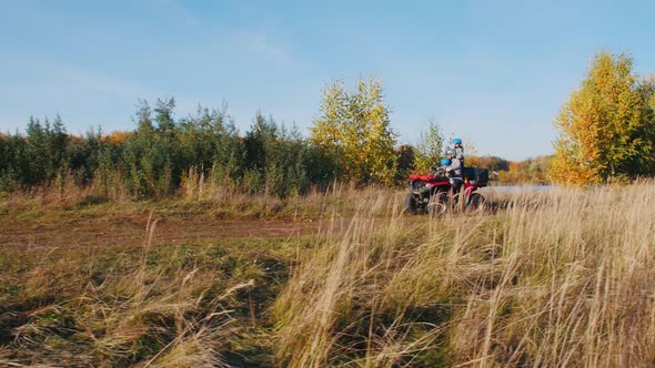 Outdoor Activity - People Riding ATVs on the Autumn Field and Stopping at an Edge Cliff