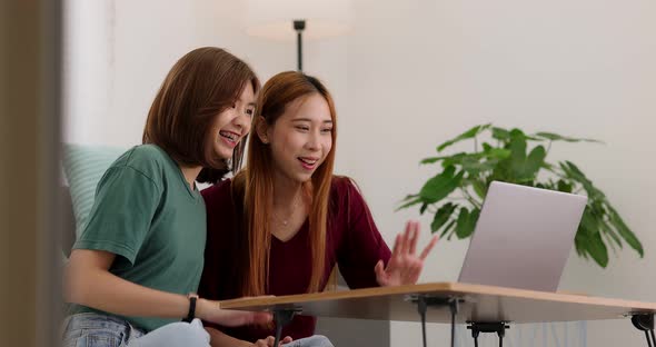 Happy Asian college student casual wear using computer working call video conference.