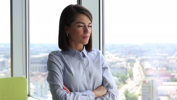 Happy Businesswoman Looking Through Window at Modern Office Enjoy Successful Day and Smiling