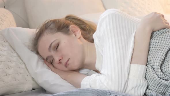 Young Woman Sleeping in Bed