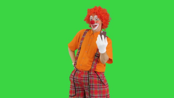 Clown Taking Selfie with His Phone on a Green Screen, Chroma Key.