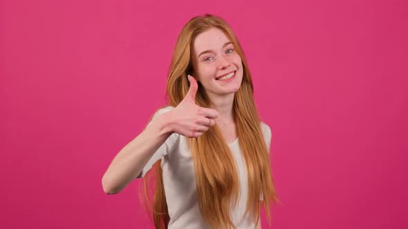 Young Redhead Woman with Freckles Doing Happy Thumbs Up Gesture with Hands