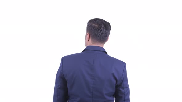 Rear View of Bearded Persian Businessman Directing and Pointing Finger