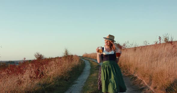 Girl with Two Pints of Light and Dark Beer Walks to Camera and Posing on Nature