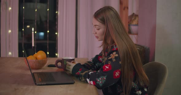 Young Female at Xmas Using Laptop Video Call