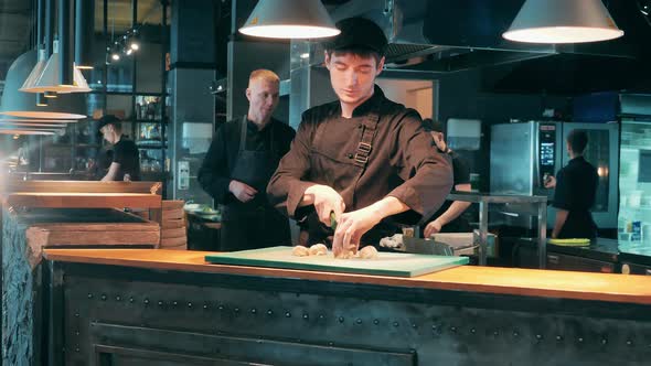 Restaurant Cook is Chopping Vegetables on the Cutting Board