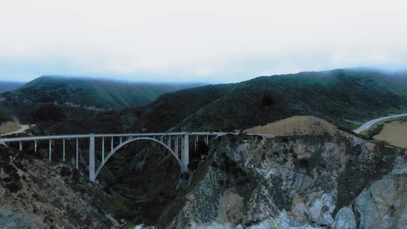 Aerial panorama of Bixby Creek Bridge between the green rocks at Big Sur, California, USA