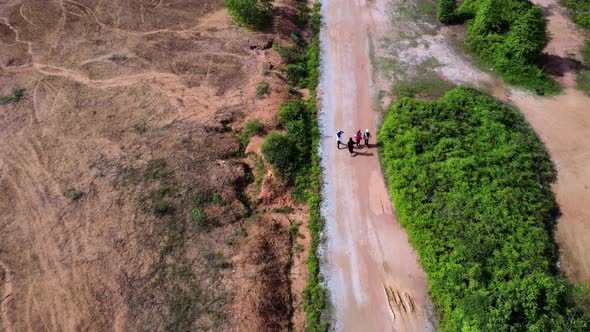 Aerial top down view Muslim girl walk at the rural path