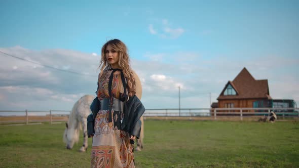 Trendy Lady Dancing Near Horses