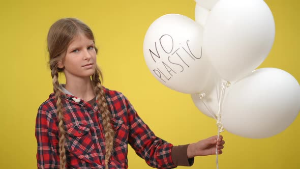 Teenage Girl at Yellow Background with White Balloons and No Plastic Written