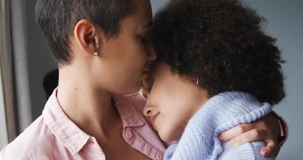 Lesbian couple romancing at window