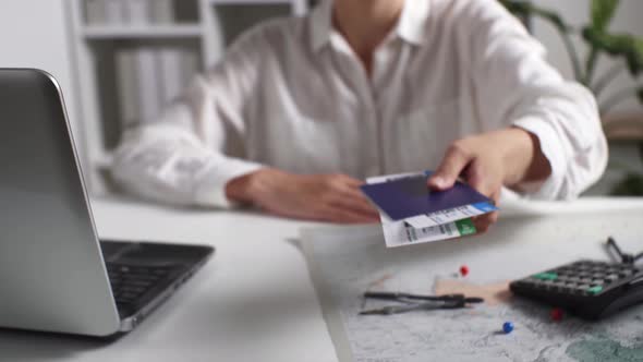 Buying Air Tickets. Woman Holds Out Tickets, Passports, Buys Plane Tickets, Working On Laptop