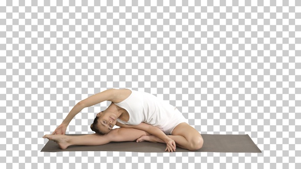 Beautiful young woman wearing white clothing doing yoga exercise