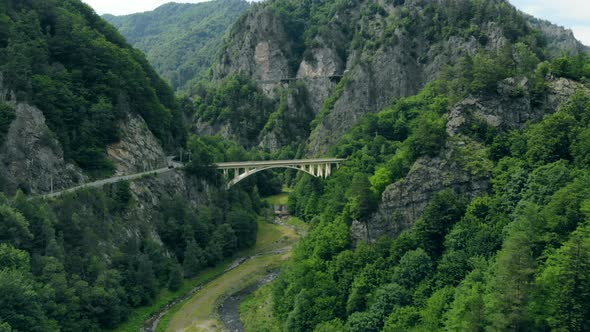 Aerial View of the Arched Bridge Connecting a Mountain Road in the Romanian Carpathians