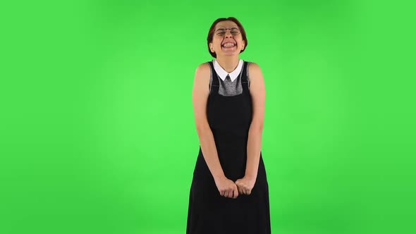 Funny Girl in Round Glasses Is Rejoicing. Green Screen