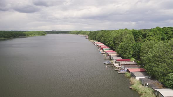 Drone shot of huts by the lakeside forest of Lake Mirow.