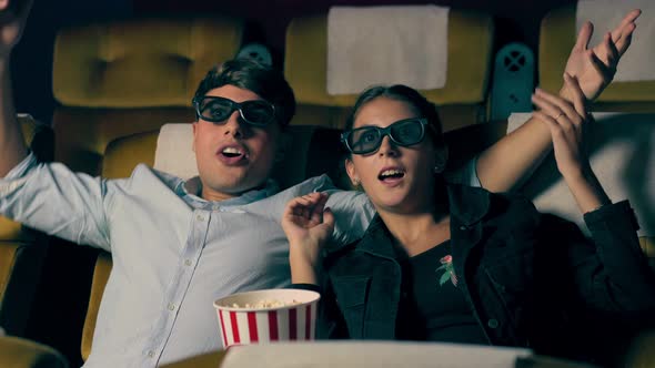 Man and Woman in the Cinema Watching a 3D Movie