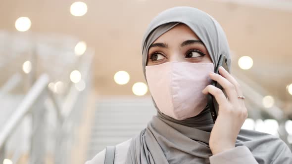 Young Muslim Woman Talking on Phone Indoors