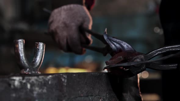 The Blacksmith Bends Oblong Piece of Metal Using Forceps