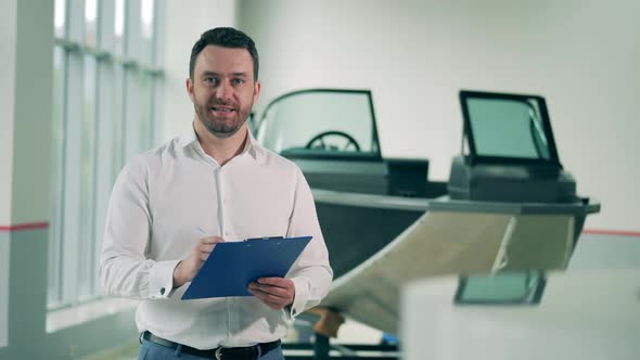 Salesman of Boats Smiling in the Showroom