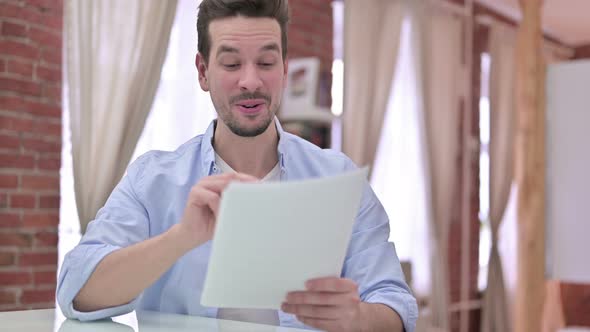 Successful Young Man Reading the Document