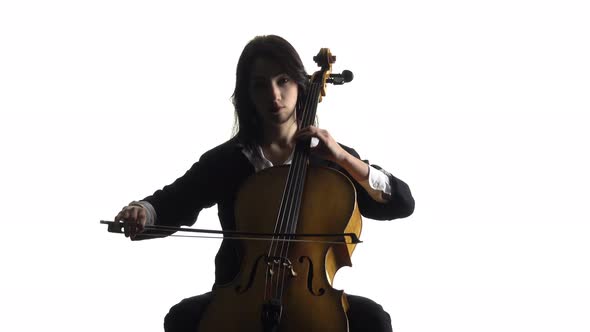 Girl in a Room Sits and Plays a Violoncello . White Background