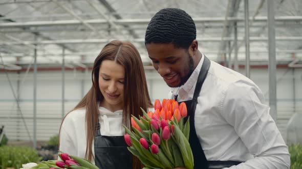Two Florists Working at Flower Indoor Plantation