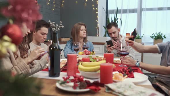 Group of Bored Upset Young Friends Using Mobile Phones Struggling of Boredom Sitting Together