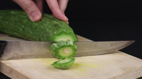 Close Up   Cutting A Raw Bitter Melon On A Cutting Board