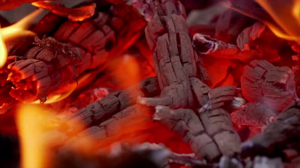 Close-up of a fire pit showing glowing red hot embers.