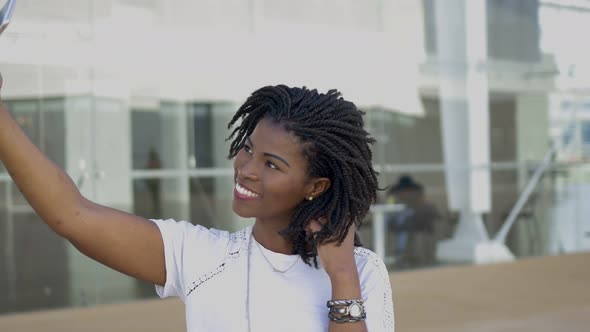 Smiling African American Girl Taking Selfie with Smartphone