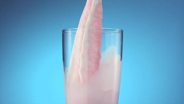 Milk and strawberry milk pouring into glass, Slow Motion alt