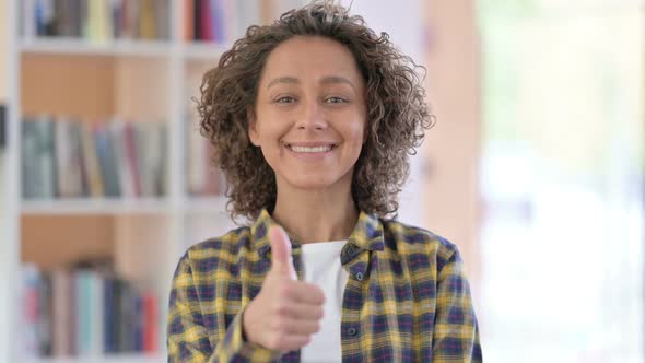 Portrait of Mixed Race Woman with Thumbs Up