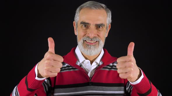 An Elderly Man Smiles and Shows a Double Thumb Up To the Camera - Black Screen Studio