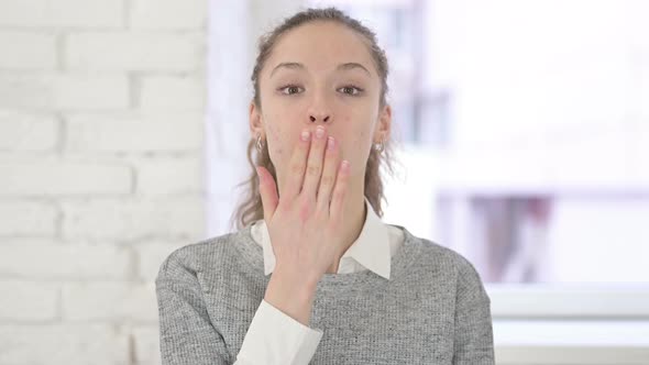 Portrait of Beautiful Young Latin Woman Giving Flying Kiss