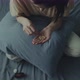 A Young Woman Sits on a Bed with Pills in Her Hands - VideoHive Item for Sale