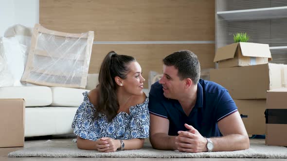 Couple Lying Down on the Floor in Their New Home