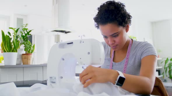 Woman stitching clothes on sewing machine