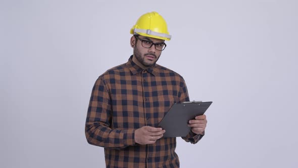 Young Bearded Indian Man Construction Worker Holding Clipboard