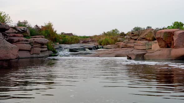 A Small Shining Stream Flows Among Smooth Wet and Dark Stones