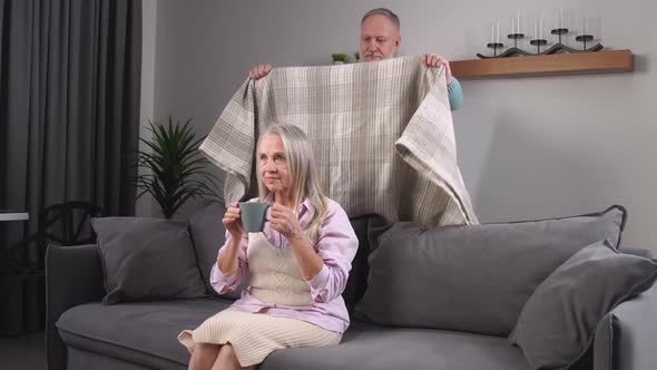 Elderly Grayhaired Man Covers His Wife with a Blanket Taking Care of Their Loved Ones Adult People