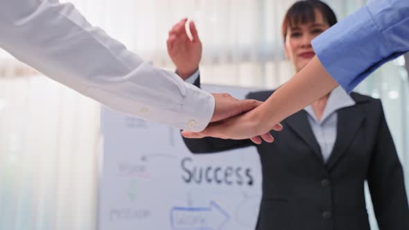 Group of businessman and woman people stack hands put palms together to motivate .