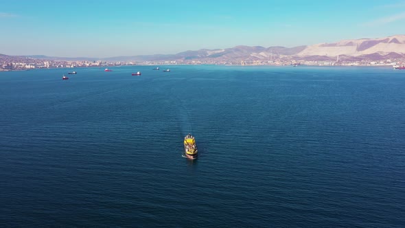 Flycam Films Yellow Vessel Crossing Boundless Ocean Surface