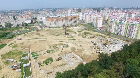 builders are working on the construction of a high-rise building in the city