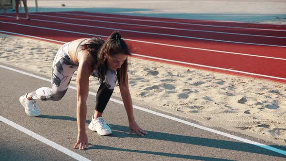 Athlete Woman Tying Running Shoes During Jog at Dawn