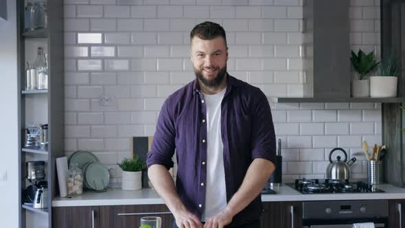 Man having Fun in the Kitchen and Eating Green Onion, Food Commercial, Copy Space